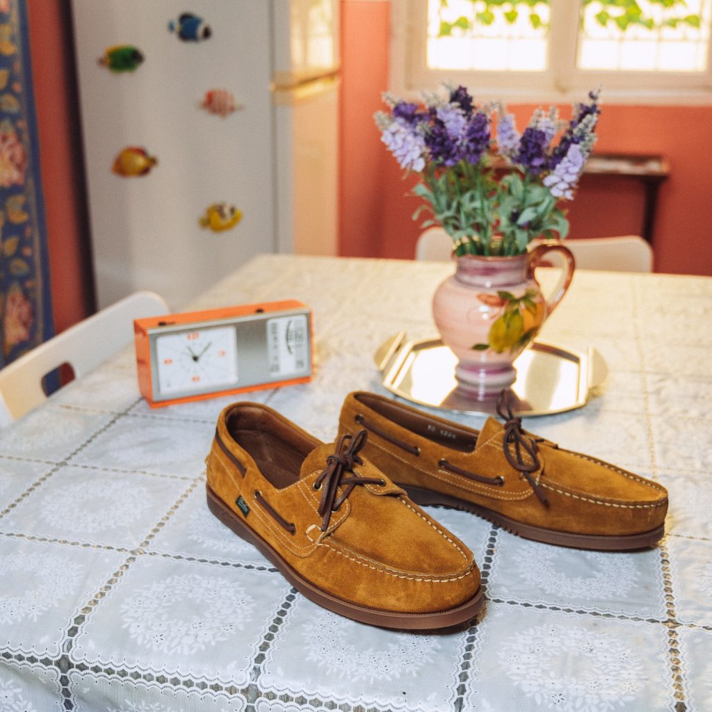 Chaussures bateau Barth en cuir velours fauve Paraboot posées sur une table estivale. Le modèle iconique Barth en cuir velours, paré pour les journées ensoleillées.